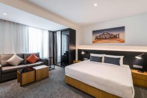 a hotel room with a large bed and a television at Hyatt House Kuala Lumpur, Mont Kiara in Kuala Lumpur