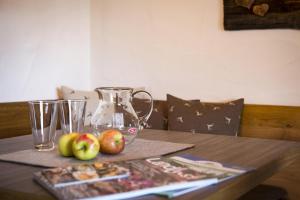 a wooden table with apples and a blender on it at Landhaus Gschwand in Krün