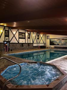 a large swimming pool with a hot tub at Three Rivers Hotel in Ferryside