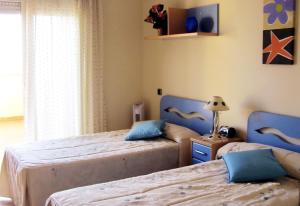 A bed or beds in a room at Beachfront San Javier