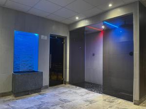 a hallway with a blue aquarium in a building at Three Rivers Hotel in Ferryside