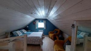 a attic bedroom with a bed and a window at Kaszubskie Marzenie in Kartuzy