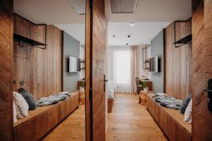 a room with wooden walls and a row of beds at JOHAN HOTEL in Zlín