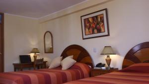 Postel nebo postele na pokoji v ubytování Copacabana Hotel + 27 fotografií