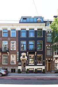 a building on the side of a street at Hotel The Neighbour's Magnolia in Amsterdam