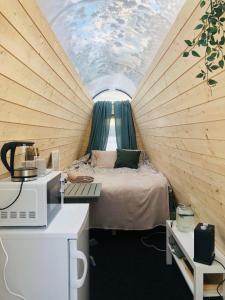 a bedroom with a bed in a tent at Niiralan Tila : Skyview Cabin in Pahajoki
