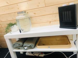 a shelf with a computer monitor on top of it at Niiralan Tila : Skyview Cabin in Pahajoki