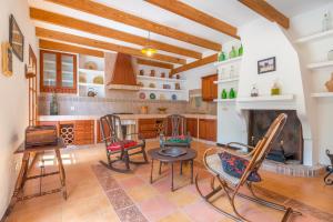 a kitchen with a table and chairs and a fireplace at Finca Es Rafalot de Dalt by Mallorca House Rent in Manacor