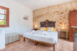 a bedroom with a large bed in a room at Finca Es Rafalot de Dalt by Mallorca House Rent in Manacor +32 photos