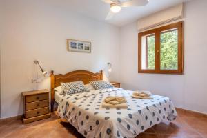 a bedroom with a bed with two towels on it at Finca Alcina by Mallorca House Rent in Felanitx +20 photos