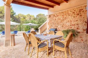 an outdoor dining room with a table and chairs at Finca Alcina by Mallorca House Rent in Felanitx