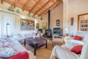 a living room with white couches and a tv at Finca Puig de l'Anar in Manacor