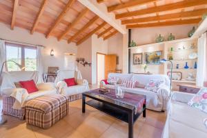 a living room with white furniture and a table at Finca Puig de l'Anar in Manacor
