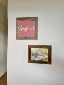 two framed pictures on a wall with the words girls art at Haus Sonnentau Wohnung 2 in Kißlegg