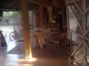 a dining room with a table and chairs at Lovely 3-Bdrm Cottage w Private Patios Pkg Sanyang in Sanyang