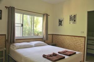 Ένα ή περισσότερα κρεβάτια σε δωμάτιο στο Pink Kangaroo Bungalows