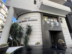 a building with a car parked in front of it at Residence San Martino in Messina