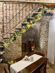 a dining room with a table and a staircase at B&B Casa Antonetti in Campo di Giove