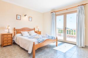 a bedroom with a bed and a large window at Es Reguerons Gran in Felanitx +25 photos