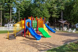 a playground with a slide in a park at Sun Outdoors Old Orchard Beach Downtown in Old Orchard Beach