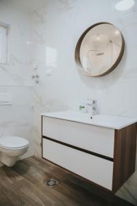 a bathroom with a sink and a mirror on the wall at My Home in Arandjelovac