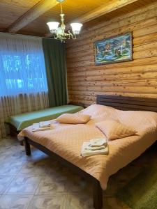 1 dormitorio con 1 cama en una habitación de madera en Chalet Mlyn, en Migovo