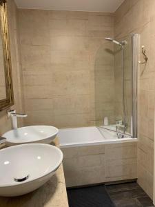 a bathroom with a white tub and a sink at Apartament Jędrzejów in Jędrzejów
