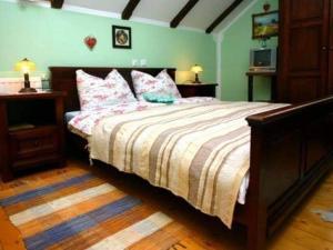 a bedroom with a large bed with pink pillows at Stara Vodenica in Klanjec