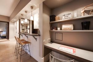 uma cozinha com um balcão e um bar com bancos em Le Sommeiller - Apartment for 2-4 people with balcony in the center em Annecy
