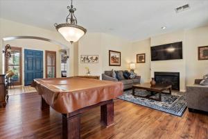 a living room with a ping pong table at Grand Ironhorse in Queen Creek