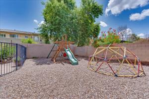 a playground with a slide and a play structure at Grand Ironhorse in Queen Creek