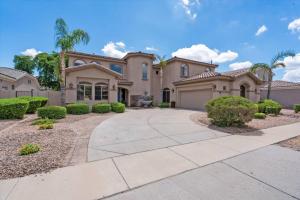 a large house with a driveway at Grand Ironhorse in Queen Creek