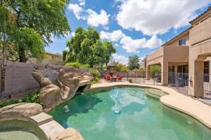 a swimming pool in a yard next to a building at Grand Ironhorse in Queen Creek
