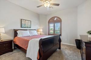 a bedroom with a bed and a ceiling fan at Grand Ironhorse in Queen Creek +38 photos