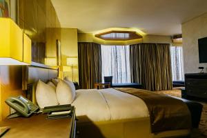 A bed or beds in a room at Lagos Continental Hotel