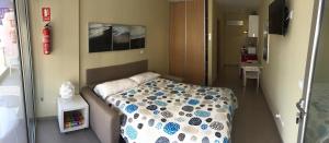 Кровать или кровати в номере Apartamentos Turisticos Maria Guerrero