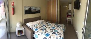 a small room with a bed in a hospital at Apartamentos Turisticos Maria Guerrero in Cabo de Palos