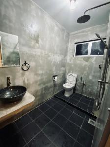 a bathroom with a sink and a toilet at Ipoh Zing Vale - Family & Couple Suite in Ipoh