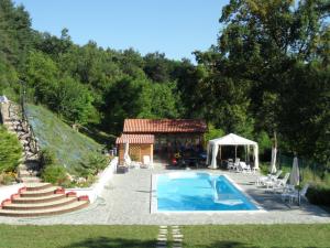 a house with a swimming pool and a gazebo at Cascina Gardina in Castellero