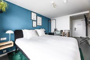 Postel nebo postele na pokoji v ubytování Gooiland Hotel