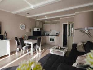 a living room with a couch and a table at Beachcomber House A in Friedrichskoog