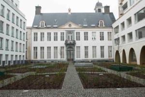 a large white building with a courtyard in front of it at CityAntwerp een Oase van rust direct achter de Meir in Antwerp