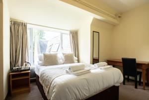 A bed or beds in a room at Grainger House Hotel