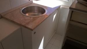 a small kitchen with a stainless steel sink on a counter at Ágnes Villa in Zalakaros