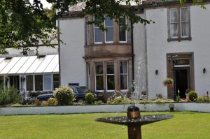 a bird bath in front of a house at Maitlandfield House Hotel in Haddington