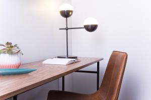 a desk with a lamp and a chair at The Sobro Guest House by AvantStay in Nashville