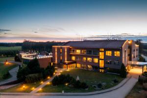 an aerial view of a building with lights at Harmony Park Hotel & SPA in Prienai