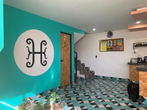 a room with a blue wall with a sign on it at Hostal Hidalgo in Guadalajara