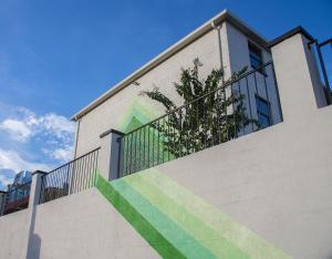 a building with a staircase with green and green stripes at SoBro Guest House by Black Swan in Nashville