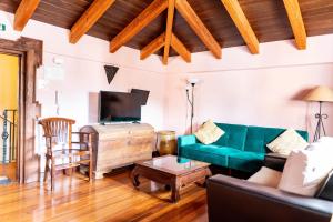 a living room with a green couch and a table at La Colegiata De Ronda in Ronda